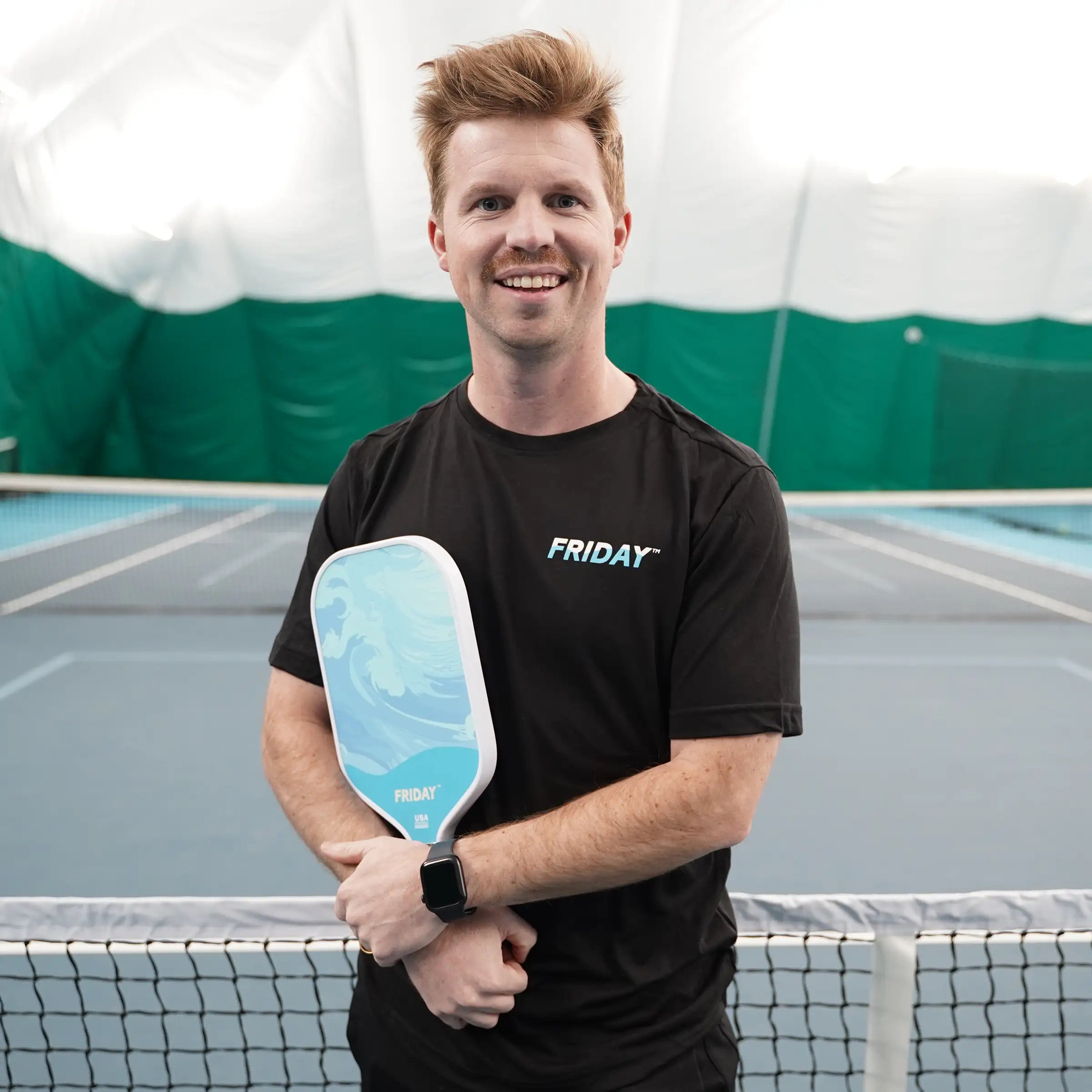 Three Friday USA Pickleball-approved paddles with colorful designs displayed on an orange background.